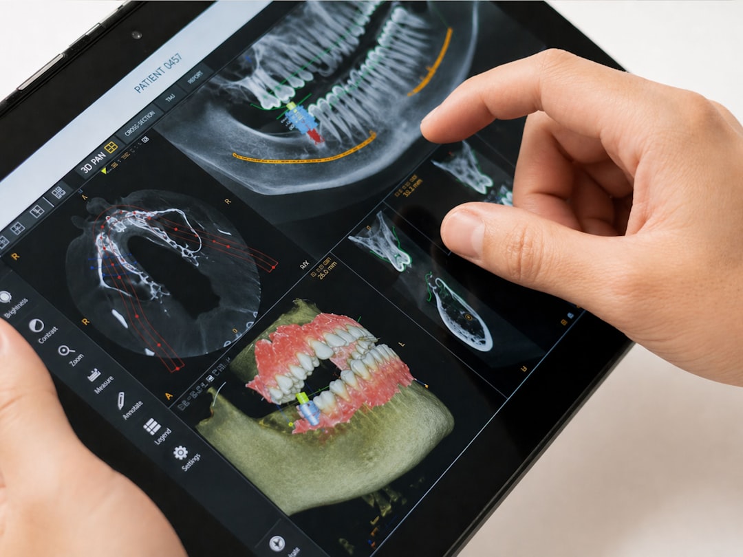 dental website mistakes — Dentist examining 3D dental scan on tablet