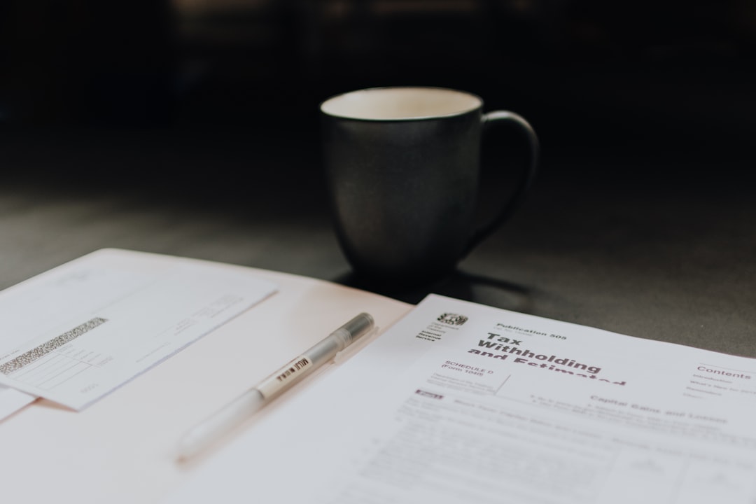 Coffee mug next to a printed agency contract on a wooden desk, ready to be read line by line