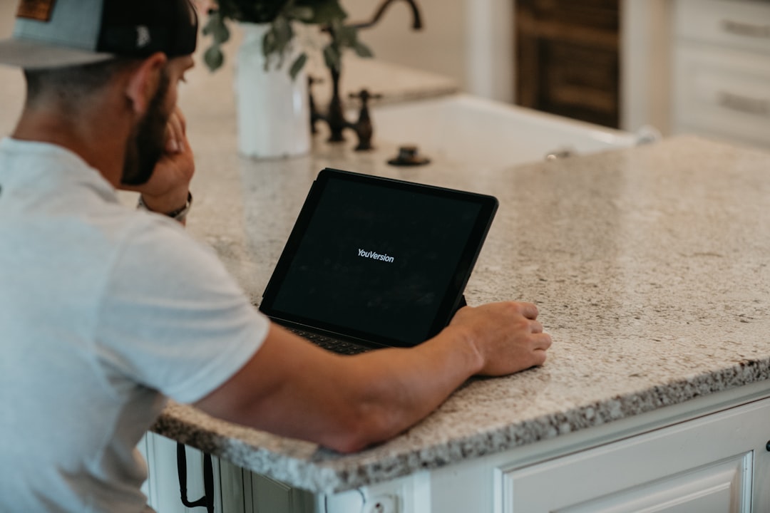 seo for plumbers — man in white t-shirt using black laptop computer