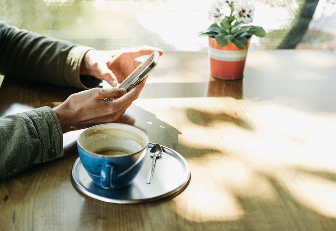 Person searching for a local dentist on their phone at a cafe
