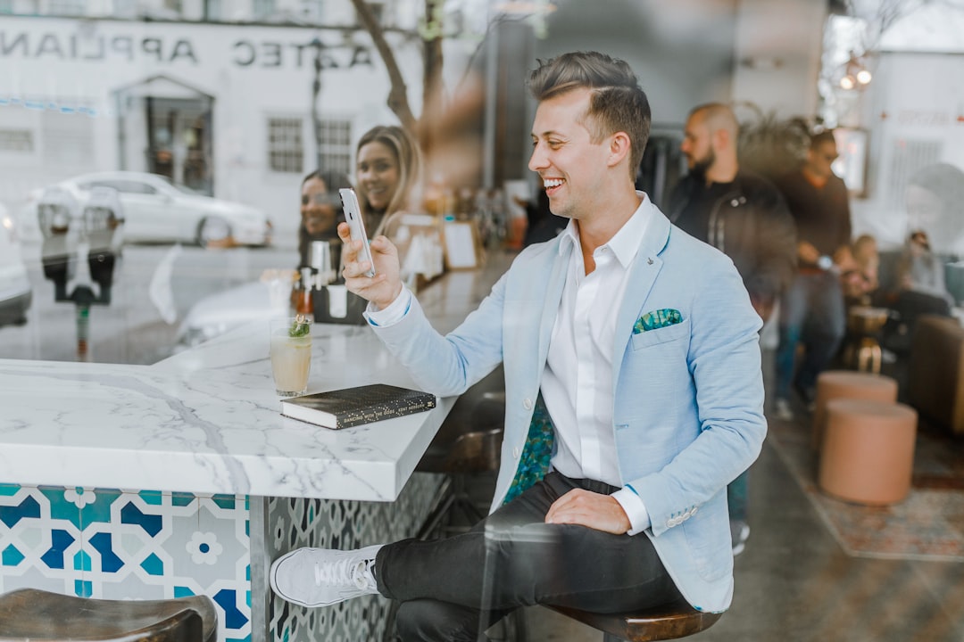 restaurant marketing agency — smiling man while holding smartphone