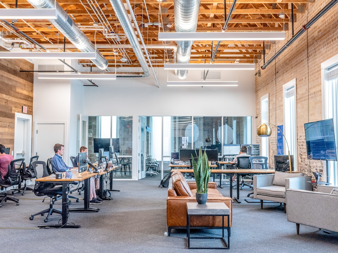 brand mentions seo — man in blue dress shirt sitting on rolling chair inside room with monitors