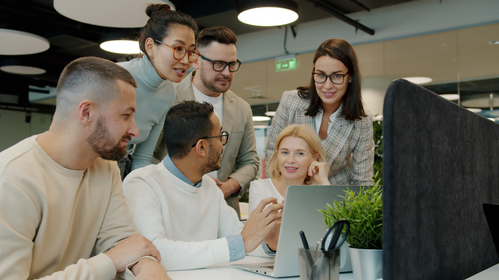 A small marketing team working together around a desk