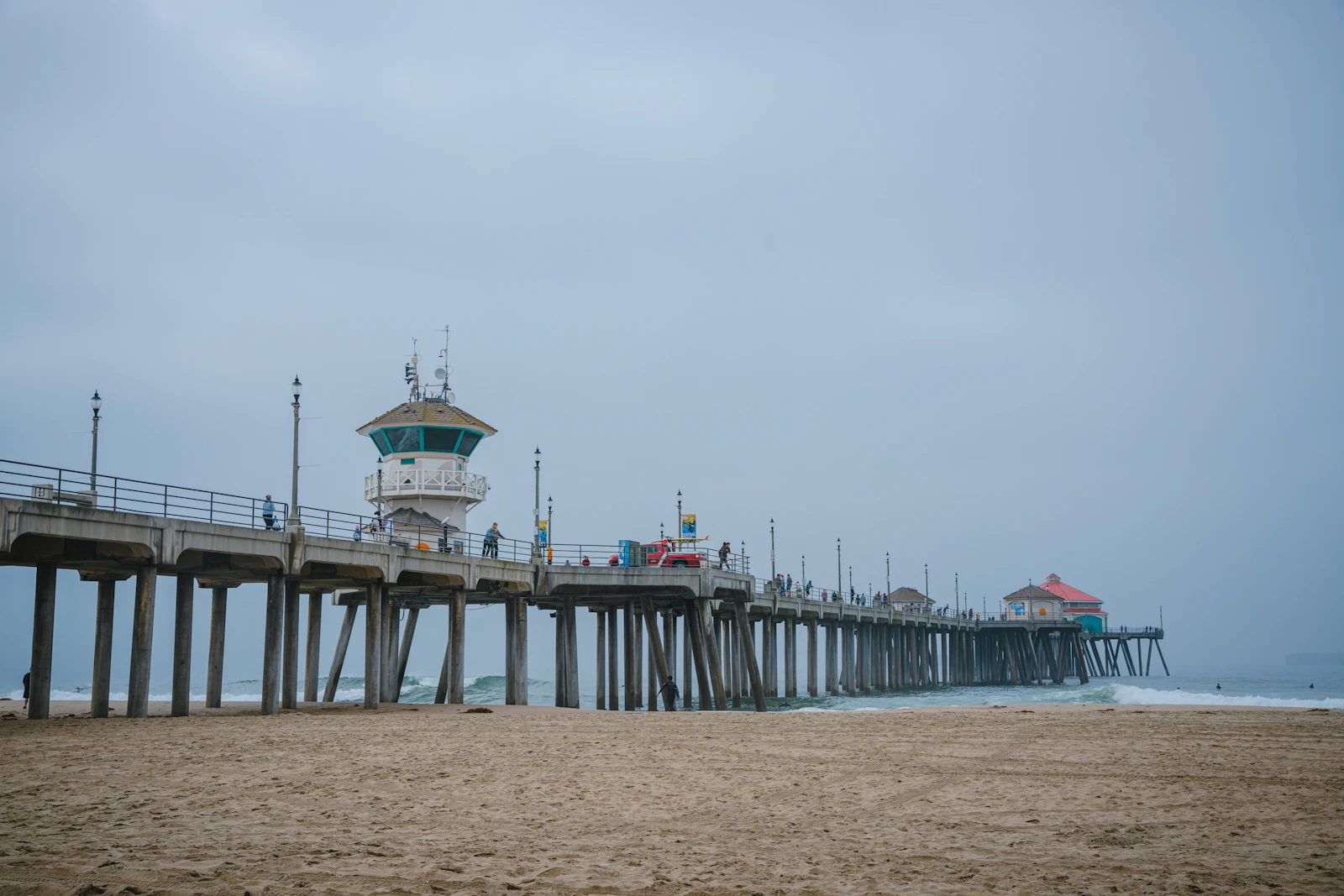 Fog rolling over the Huntington Beach coastline at dawn
