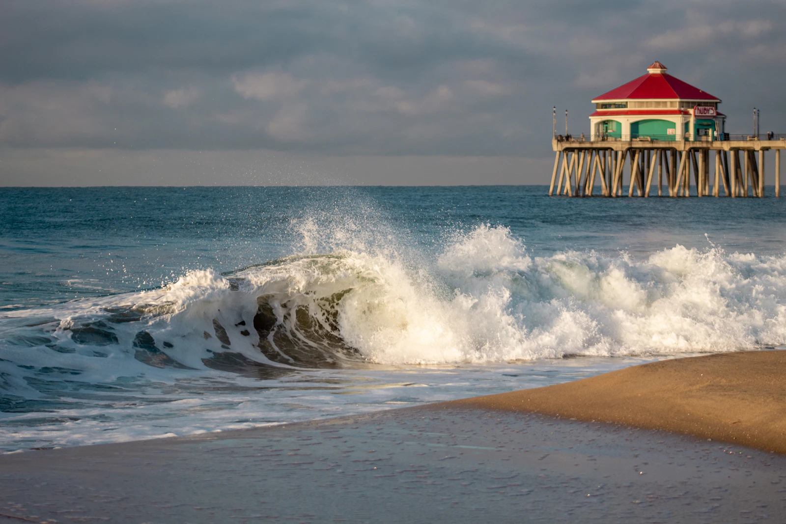 Huntington Beach pier stretching into the Pacific at golden hour