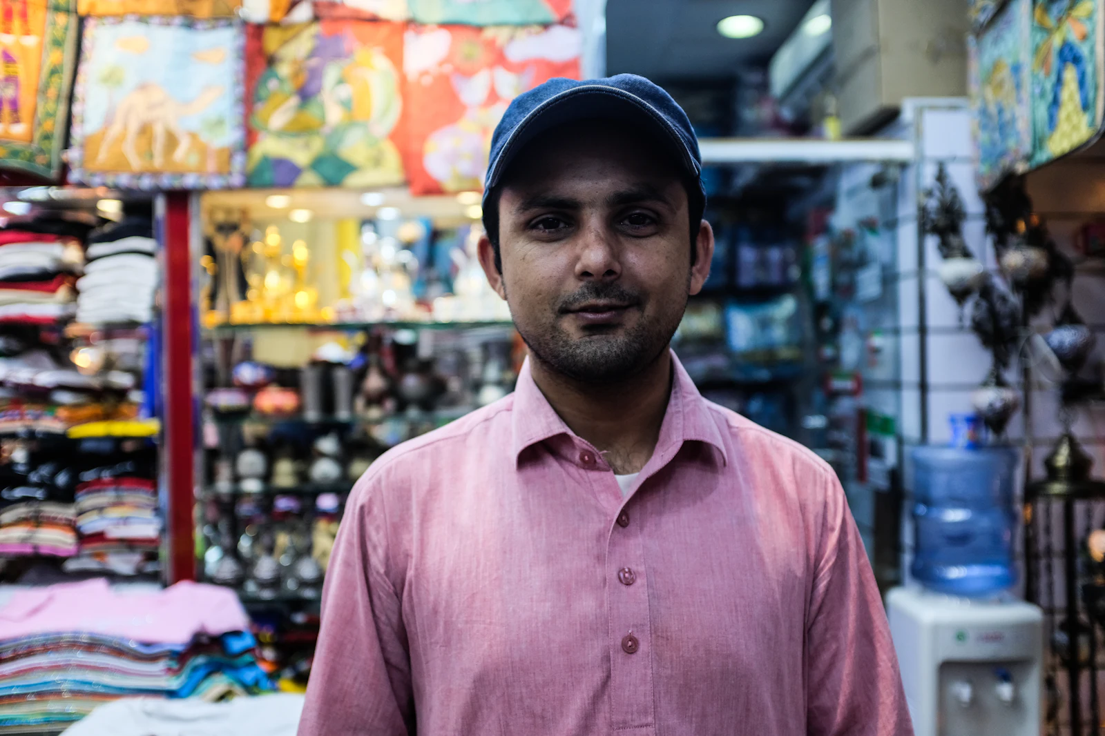 A local business owner standing at the counter of their shop
